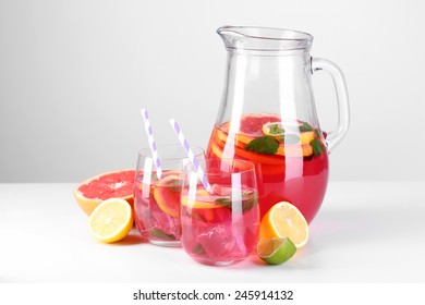 Pink Lemonade In Glasses And Pitcher Isolated On White