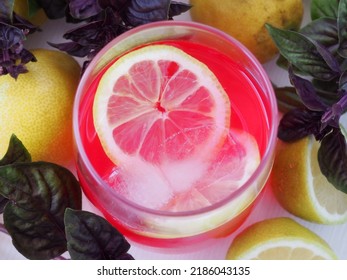 Pink Lemonade Made From Purple Basil And Lemon. Top View Of A Glass With A Drink, A Slice Of Lemon. Close Up. Selective Focus.