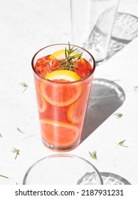 Pink Lemonade With Rosemary In Glass On White Background