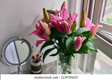 Pink Lilies In The Glass Vase On The Marble Vanity Table