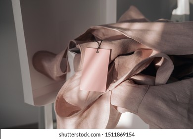 Pink Linen Dress With Tag In White Box. Branding Mockup. Fashion Blogging Concept. Direct Sunlight, Lights And Shadows Photography