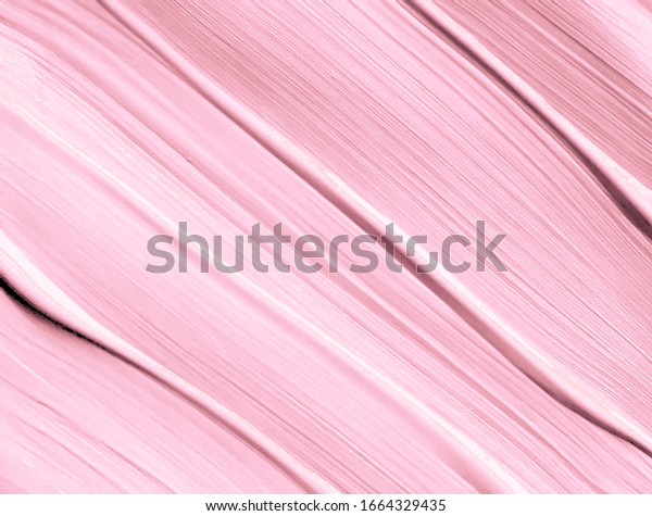 Pink lipstick smudged background. Lipstick or\
other makeup product swatch. Acrylic paint smeared texture. Pink\
gouache brush painted wallpaper. Can be used as an advertisement\
banner, text background.