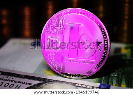 Pink Litecoin LTC coin is surrounded by a money background.
