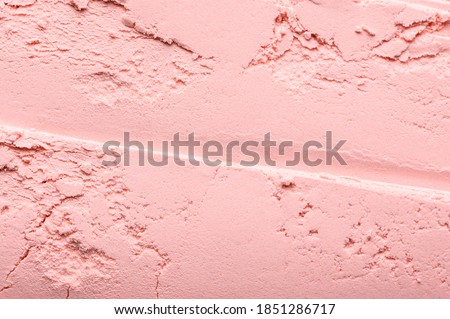 Pink loose blush texture. Powder for correcting face tone. Natural mineral make-up product for a perfect complexion. Cosmetic female beauty product scattered on the surface, close-up