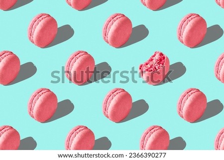 Pink macarons with hard shadows on colored background. Seamless pattern of popular French cookies. Yummy background. Trendy Barbie style concept