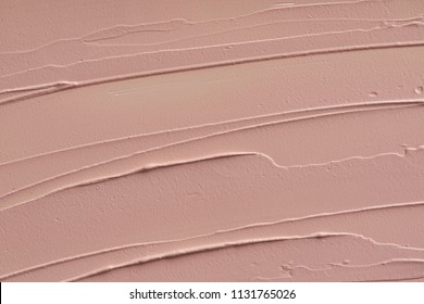 Pink makeup smear of creamy foundation isolated on white background. Pink creamy foundation texture background