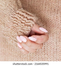 Pink Manicure On The Texture Of A Brown Sweater, Hand Care, Pastel Colors Of Manicure, 