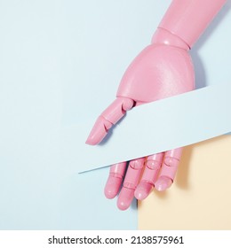 Pink mannequin hand with blue card note. Creative copyspace. Flat lay.