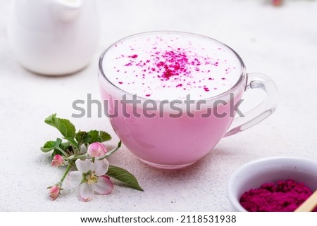 Pink matcha latte with milk. Trendy drink from dragon fruit powder