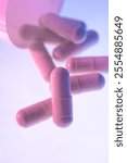 Pink Medication Capsules on Blue Background