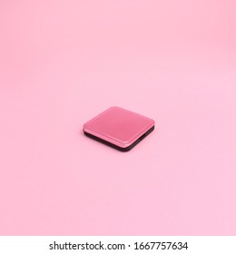 A Pink Metal Folding Hand Mirror Closed On Pink Background