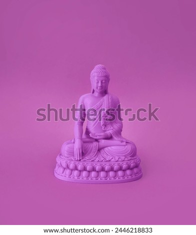 Pink mini Buddha figure on pink background