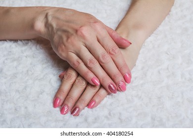 Pink nail art with flower on white textile