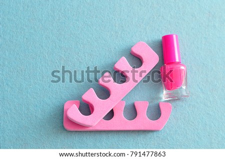 Pink nail polish with pink toe dividers 