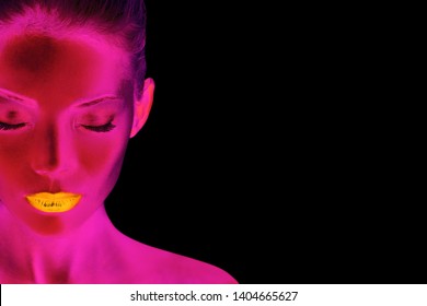 Pink Neon Body Paint Blacklight Glow In The Dark Futuristic Asian Beauty Woman Model In Nightclub Wearing Sexy Gold Lips Makeup. Black Background.