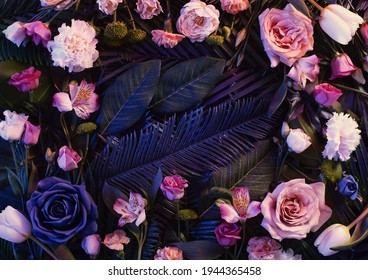 Pink neon lights  colorful flowers arrangement  with natural green  leaves. Minimal flower concept. Flat lay. Abstract floral composition. - Shutterstock ID 1944365458