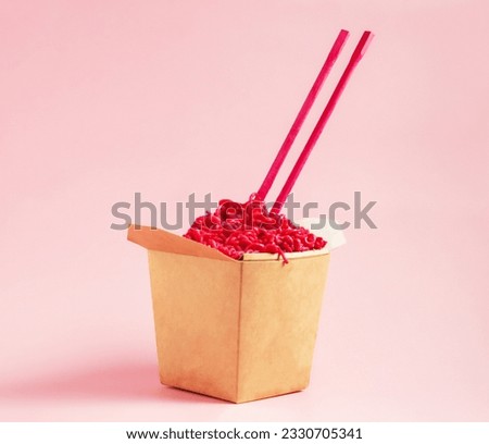 Pink noodles with pink chopsticks on pink background. Trendy pink pasta takeaway.  