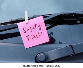 Pink Note Clip With Car Wind Shield Wiper, With Text Written SAFETY FIRST, To Advise Departing Person To Be Careful While Driving Or Parents Remind Teenage Driver To Drive Vehicle With Responsibility