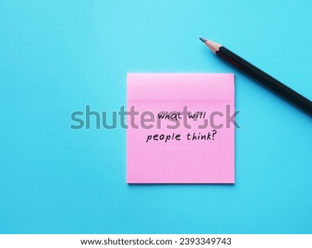 Pink note on blue background with handwriting text WHAT WILL PEOPLE THINK? means suffering anxiety around being judged, fear of feeling criticised by others, approval addiction or seeking
