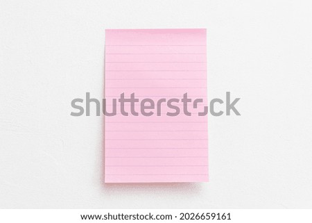 A pink note on a light background with copy space. 