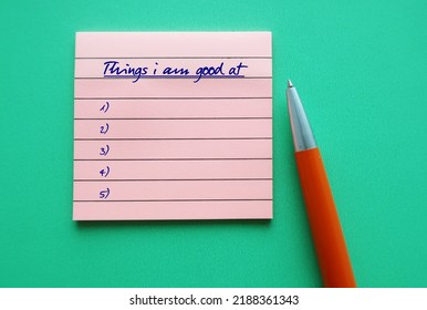 Pink note and pen on green background with list of Things I am Good At - concept of figure out strengths, discover hard and soft skills to find passion or unique abilities - Shutterstock ID 2188361343