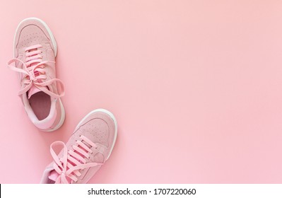 Pink Nubuck Sneakers Isolated On A Pink Background, Seasonal Shoes For Walking And Sports, Top View