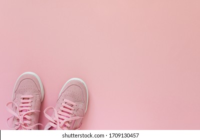 Pink Nubuck Sneakers Isolated On A Pink Background, Seasonal Shoes For Walking And Sports, Top View