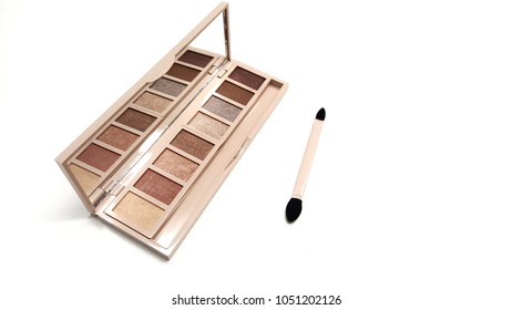 A Pink Nude Tone Of Eyeshadow Palette In Pink Case With Mirror And Two Way Brushes For Woman Isolated On White Background. Professional Makeup Concept. Copy Space With Text.