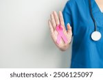 Pink October Breast Cancer Awareness month, woman doctor with pink Ribbon in hospital for support people life and illness. National cancer survivors month, Mother and World cancer day concept