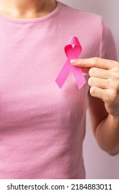 Pink October Breast Cancer Awareness Month, Woman Hand Hold Pink Ribbon And Wear Shirt For Support People Life And Illness. National Cancer Survivors Month, Mother And World Cancer Day Concept