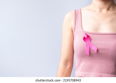 Pink October Breast Cancer Awareness Month, Woman Hand Hold Pink Ribbon And Wear Shirt For Support People Life And Illness. National Cancer Survivors Month, Mother And World Cancer Day Concept