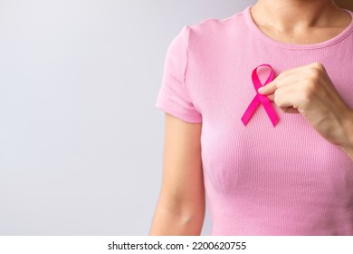 Pink October Breast Cancer Awareness month, woman hand hold pink Ribbon and wear shirt for support people life and illness. National cancer survivors month, Mother and World cancer day concept - Shutterstock ID 2200620755