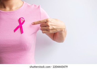 Pink October Breast Cancer Awareness Month, Woman Hand Hold Pink Ribbon And Wear Shirt For Support People Life And Illness. National Cancer Survivors Month, Mother And World Cancer Day Concept