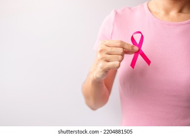 Pink October Breast Cancer Awareness month, woman hand hold pink Ribbon and wear shirt for support people life and illness. National cancer survivors month, Mother and World cancer day concept - Shutterstock ID 2204881505