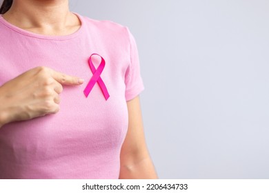 Pink October Breast Cancer Awareness month, woman hand hold pink Ribbon and wear shirt for support people life and illness. National cancer survivors month, Mother and World cancer day concept - Shutterstock ID 2206434733