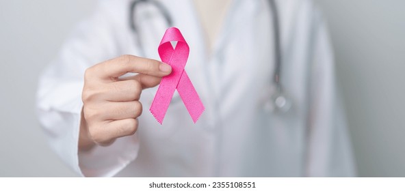 Pink October Breast Cancer Awareness month, doctor with pink Ribbon in hospital for support people life and illness. National cancer survivors month, Mother and World cancer day concept - Powered by Shutterstock