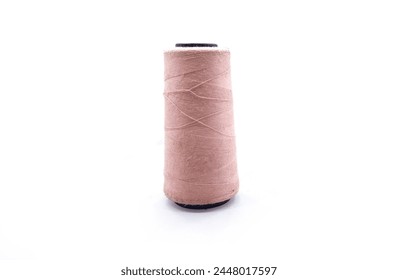 Pink old Thread Cone with copy space, Your Space for Creative Expression, pink color cotton yarns or thread. Cone of pink synthetic or cotton threads isolated on white background. textile manufacture