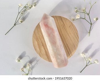 pink opal tower crystal on wood white plain background 