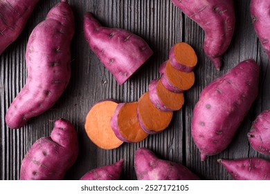 Pink organic raw sweet potatoes, whole and sliced, on wooden rustic table close up - Powered by Shutterstock