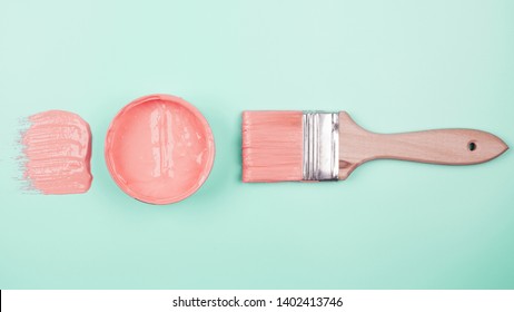 Pink Paintbrush And Paint Bucket On Mint Background