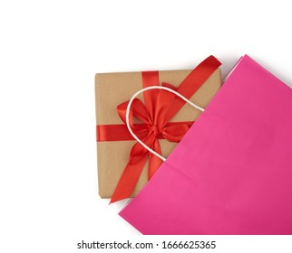 Pink Paper Bag With A Gift Box On A White Background, Concept Of Shopping And Giving A Gift, Flat Lay