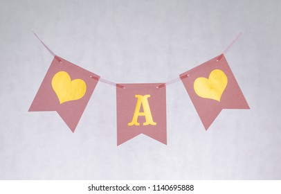 Pink paper celebration letters. A writing. White isolated background