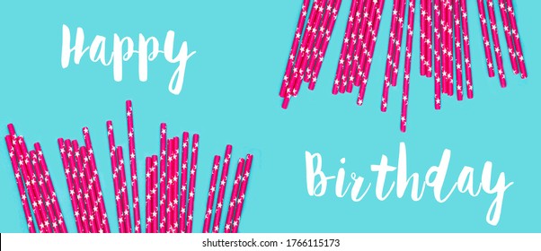 pink Paper Drinking Straws with  Stars Pattern Scattered as Border Frame on blue Background. Birthday Party concept