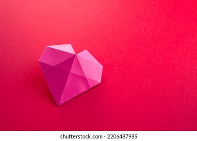 Pink paper heart origami isolated on a blank red background. Valentines day card - Shutterstock ID 2206487985