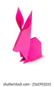 Pink paper rabbit origami isolated on a blank white background.