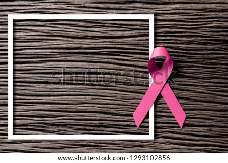 Pink paper ribbons on old wooden floors, background images for use on World Cancer Day.