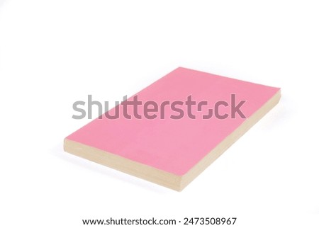 A Pink paperback book with only a barcode on the cover. Literature and alternative lifestyle concepts.