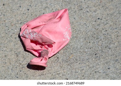 Pink Party Balloon Deflated On The Sidewalk