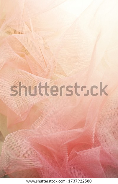 Pink pastel background. Fashion. Pink chiffon.\
Sewing. Sunlight morning. Pastel vintage. Luxury. Wedding\
decoration. Bridal. Fashion.  Accessory. Chiffon dress. Clothing.\
Fabric. Pink dress.\
Abstract