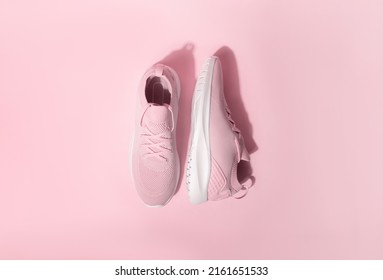 Pink pastel color sneakers on background 